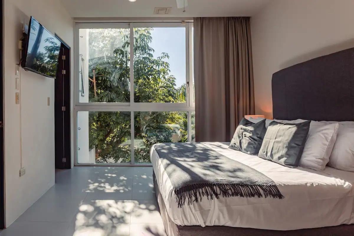 Bedroom with garden view at Iboga Wellness Institute Casa Centro in Cozumel