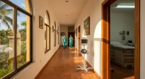 Sunlit medical clinic hallway in Cozumel showing cardiac monitoring equipment and tropical views through windows